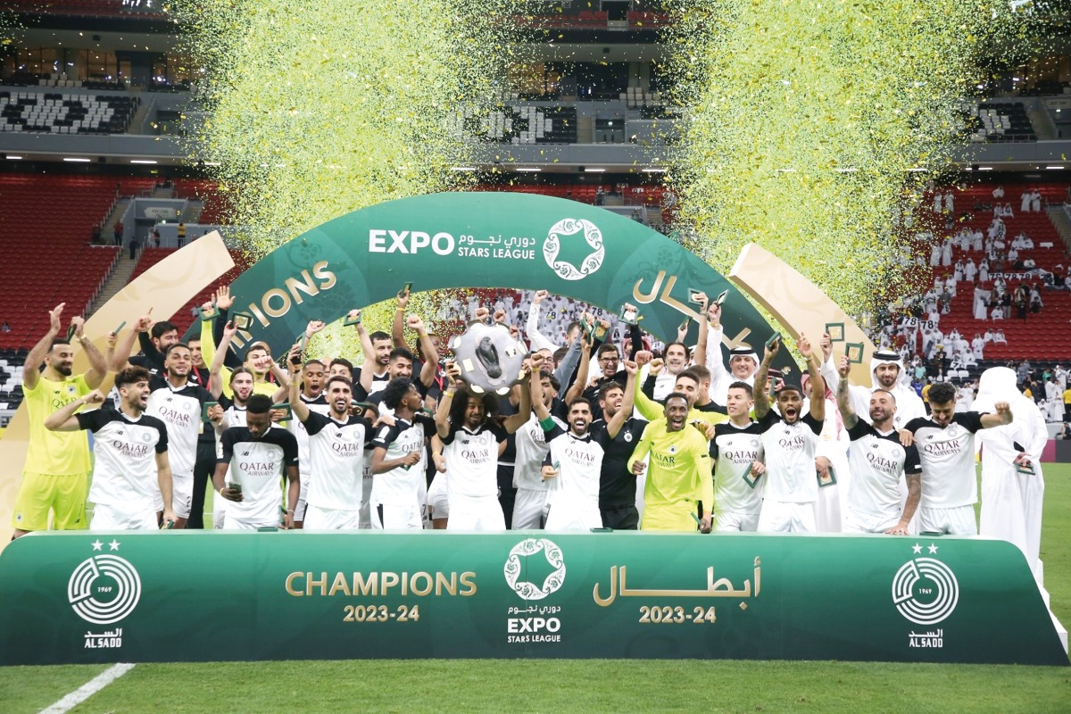 Akram Afif lifts the Falcon Shield as Al Sadd's players celebrate after sealing the ESL title. 