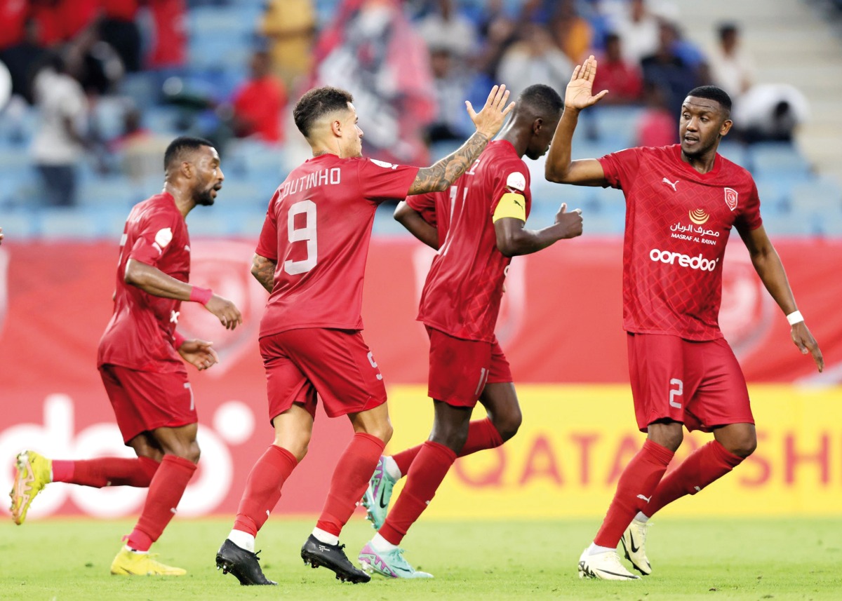 Al Duhail's Philippe Coutinho (second left) celebrates  with teammates after scoring his team's first goal against Al Shamal, yesterday.