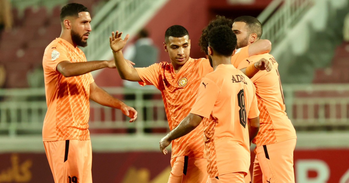 Oussama Tannane (right) celebrates with teammates after scoring Umm Salal's first goal.