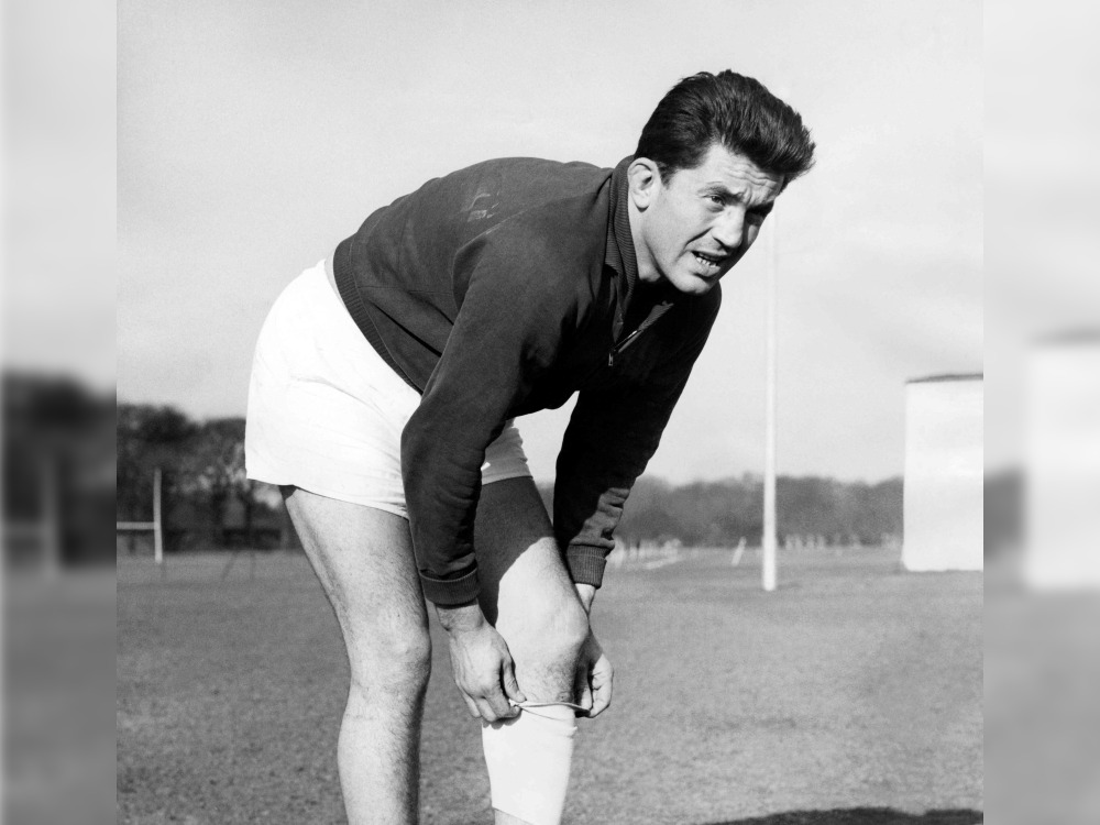 (FILES) In preparation for their match against England at Twickenham, French rugby union player Lucien Mias, captain of the French Rugby union team, puts a bandage over his injured knee during a fitness test on February 27, 1959 at Athletic Ground of Richmond, Greater London, United Kingdom. (Photo by AFP)
