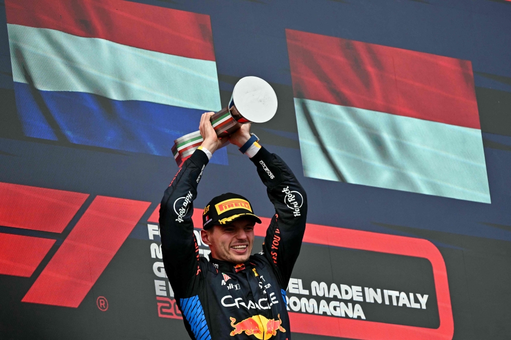 Race winner Red Bull Racing's Dutch driver Max Verstappen holds his trophy on the podium of the Emilia Romagna Formula One Grand Prix at the Autodromo Enzo e Dino Ferrari race track in Imola on May 18, 2024. (Photo by ANDREJ ISAKOVIC / AFP)