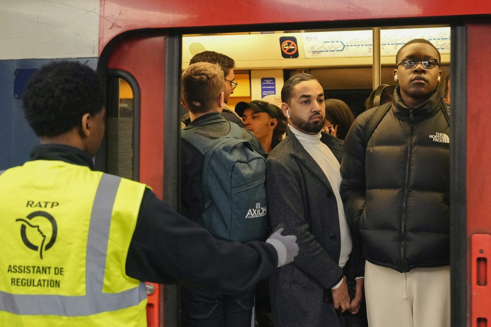 Commuters stand in a crowded train at Chateletes Halles RER station in Paris on May 21, 2024, during a strike called by SNCF employees, in which 1 in 5 trains is scheduled by the French railway company. Photo by Dimitar DILKOFF / AFP