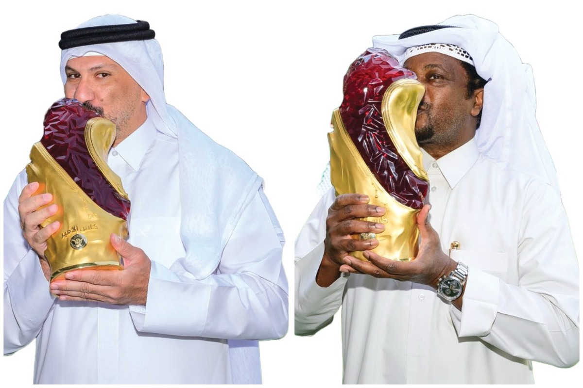 Al Sadd coach Wesam Rizk (left) and Qatar SC coach Youssef Al Noubi pose with the Amir Cup trophy yesterday. 