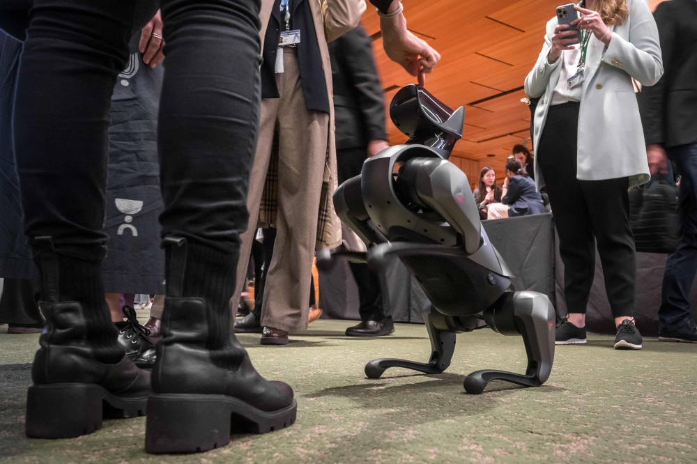 A robot using artificial intelligence is seen at a stand during the International Telecommunication Union (ITU) AI for Good Global Summit in Geneva on May 30, 2024. Photo by Fabrice COFFRINI / AFP.