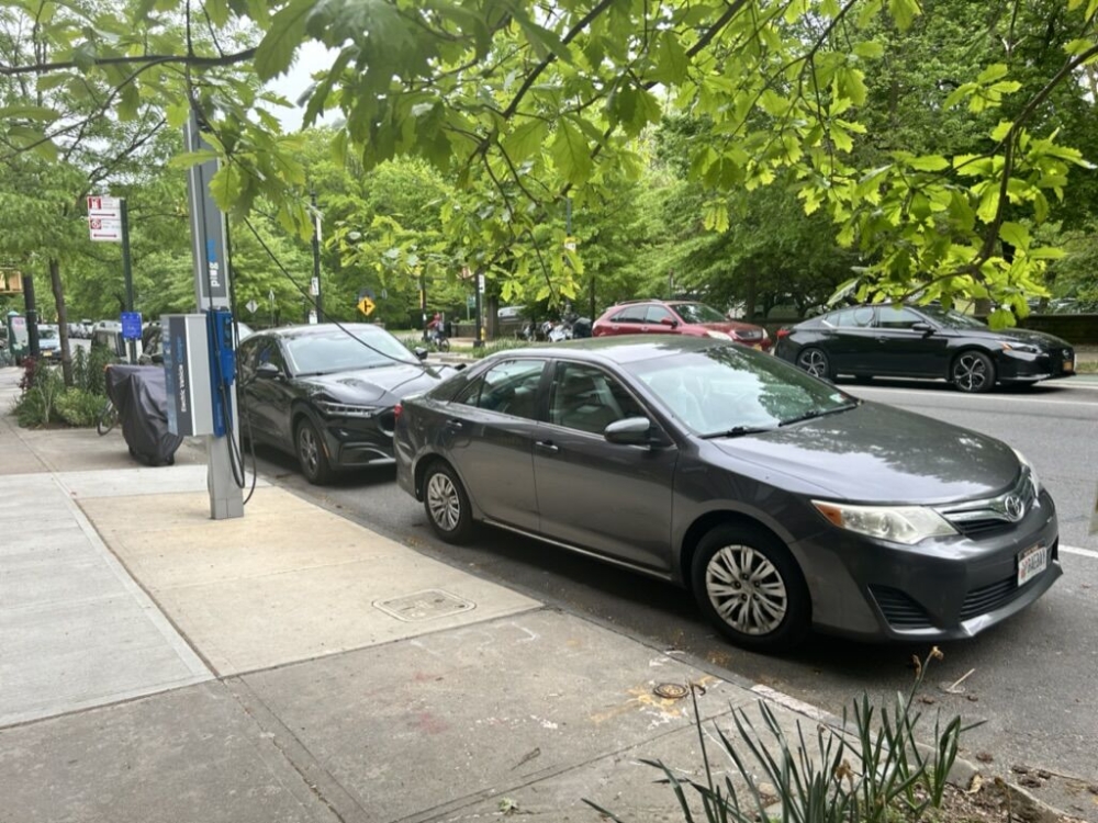 An internal-combustion Toyota Camry blocks a FLO EV charger near Stephanie Doba’s home in Park Slope. MUST CREDIT: Alicia Clanton/Bloomberg