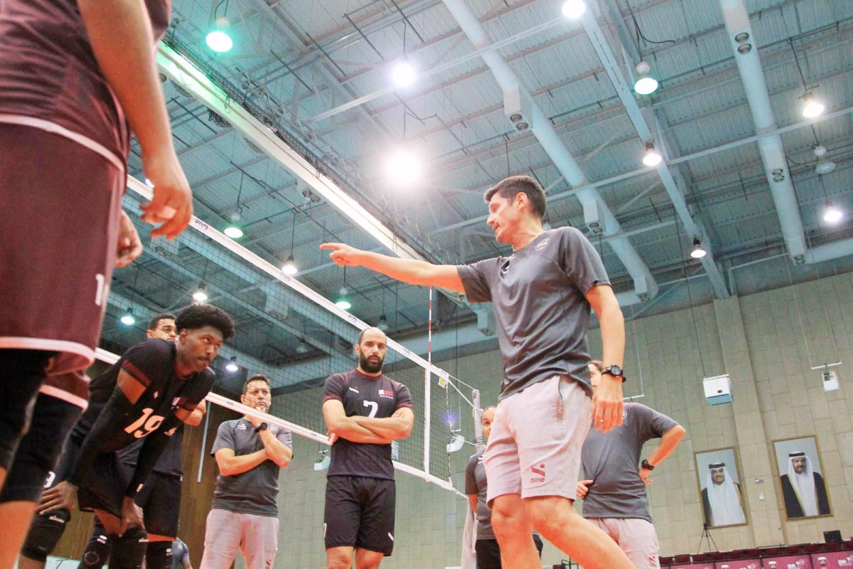 Qatar coach Camilo Soto supervises team's training session. 