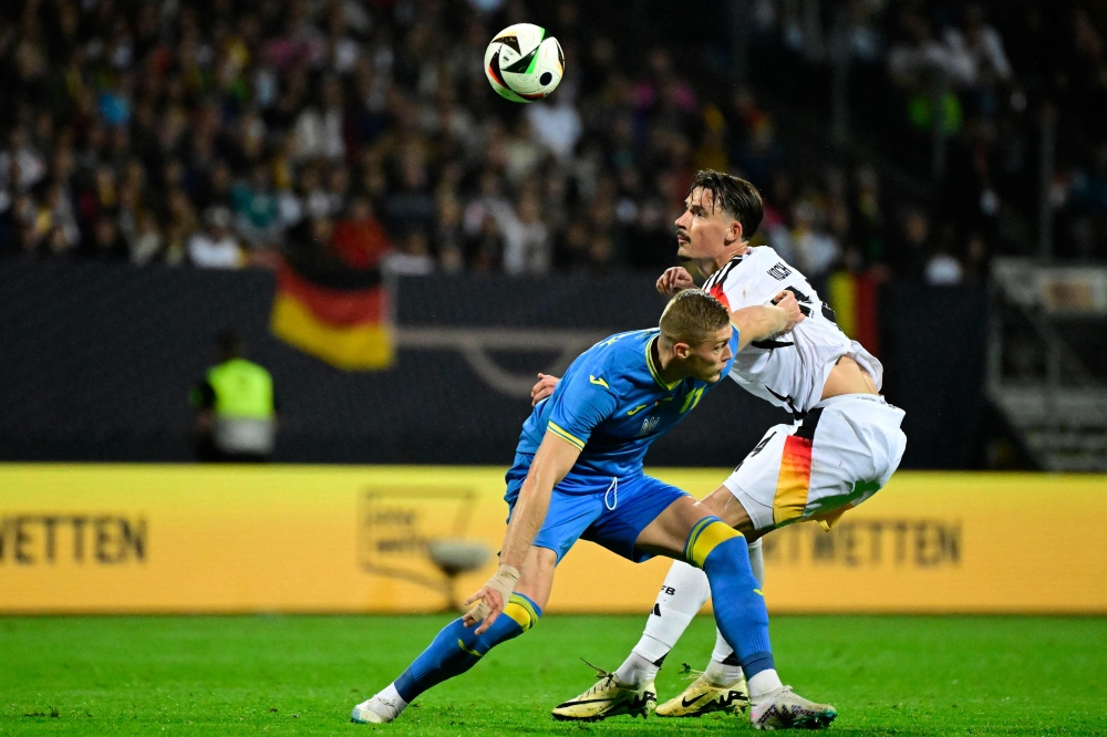 Ukraine's forward #11 Artem Dovbyk and Germany's defender #24 Robin Koch vie for the ball during the friendly football match Germany v Ukraine, in Nuremberg, eastern Germany, on June 3, 2024. (Photo by Tobias Schwarz / AFP)