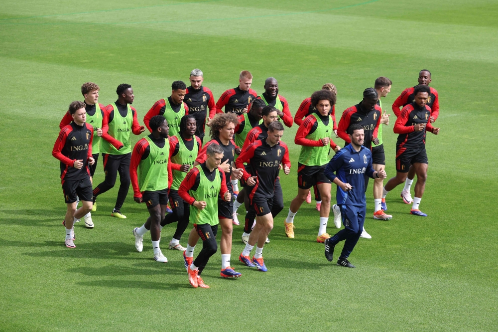 Belgium's players and physical coach Vladimir Cepzanovic (in blue) warm up during a training session as part of the team's preparation for the Euro 2024 European football championships at the Royal Belgian Football Association's training center in Tubize, on June 4, 2024. (Photo by Virginie Lefour / Belga / AFP) 
 