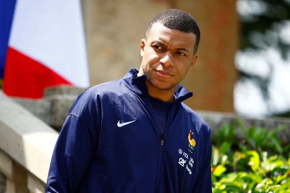 French forward Kylian Mbappe waits for the arrival of French President for a lunch at the team's training camp, as part of the team's preparation for the UEFA Euro 2024 European football championships in Clairefontaine-en-Yvelines on June 3, 2024. (Photo by Sarah Meyssonnier / POOL / AFP)