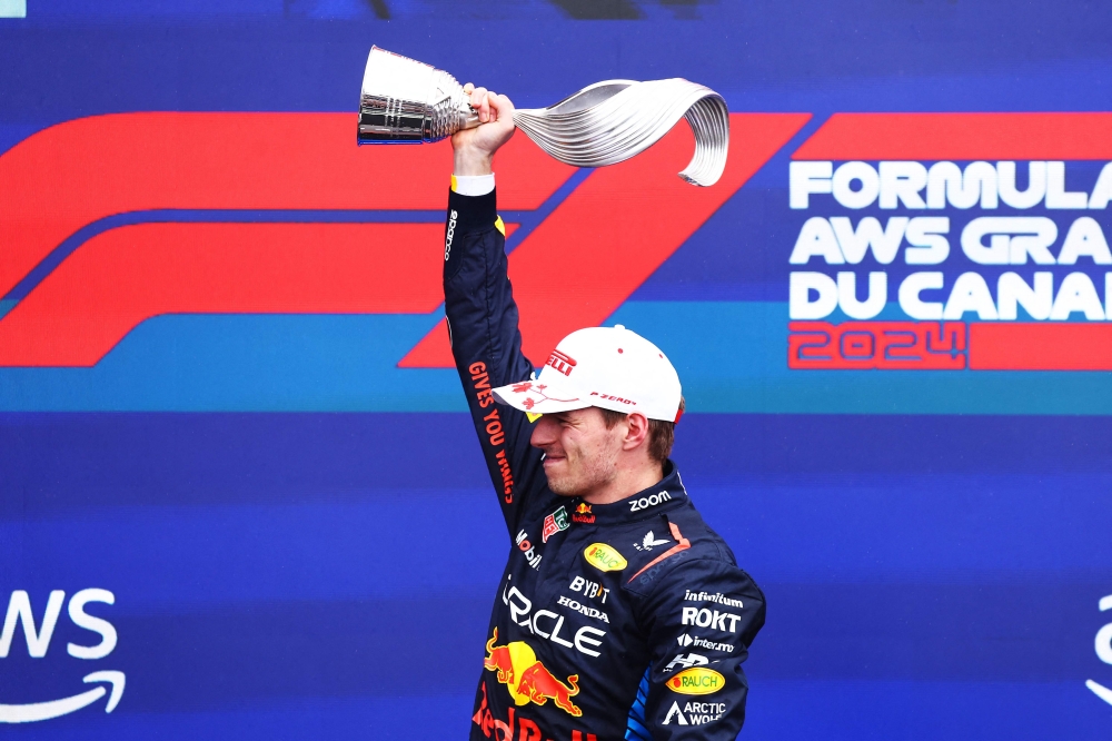 Race winner Max Verstappen of the Netherlands and Oracle Red Bull Racing celebrates with his trophy on the podium after the F1 Grand Prix of Canada at Circuit Gilles Villeneuve on June 09, 2024 in Montreal, Quebec. (Photo by Mark Thompson/Getty Images via AFP)