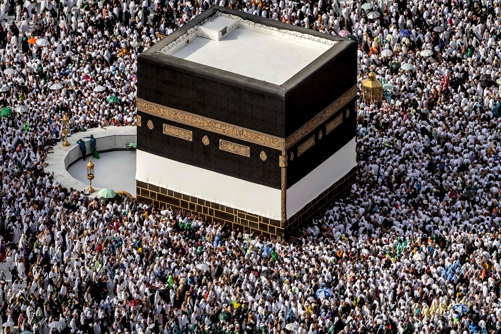 Worshippers pray around the Kaaba, Islam's holiest shrine, at the Grand Mosque in Saudi Arabia's holy city of Mecca on June 11, 2024 ahead of the annual hajj pilgrimage. (Photo by Fadel Senna / AFP)