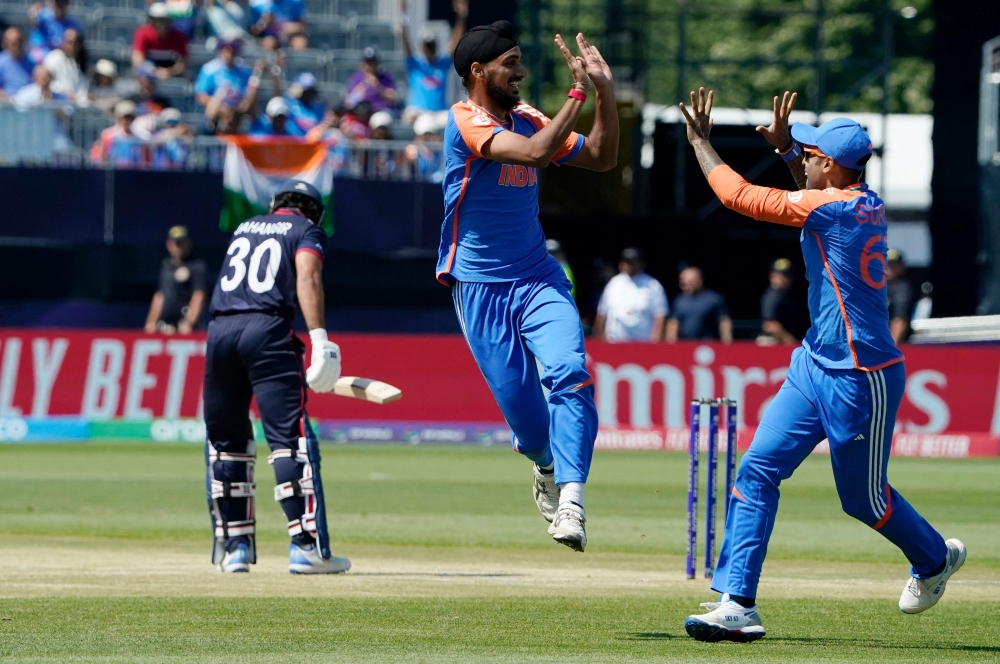 India's Arshdeep Singh celebrates a successful lbw with teammate India's Suryakumar Yadav (R) during the ICC men's Twenty20 World Cup 2024 group A cricket match between the USA and India at Nassau County International Cricket Stadium in East Meadow, New York on June 12, 2024. (Photo by Timothy A. Clary / AFP)