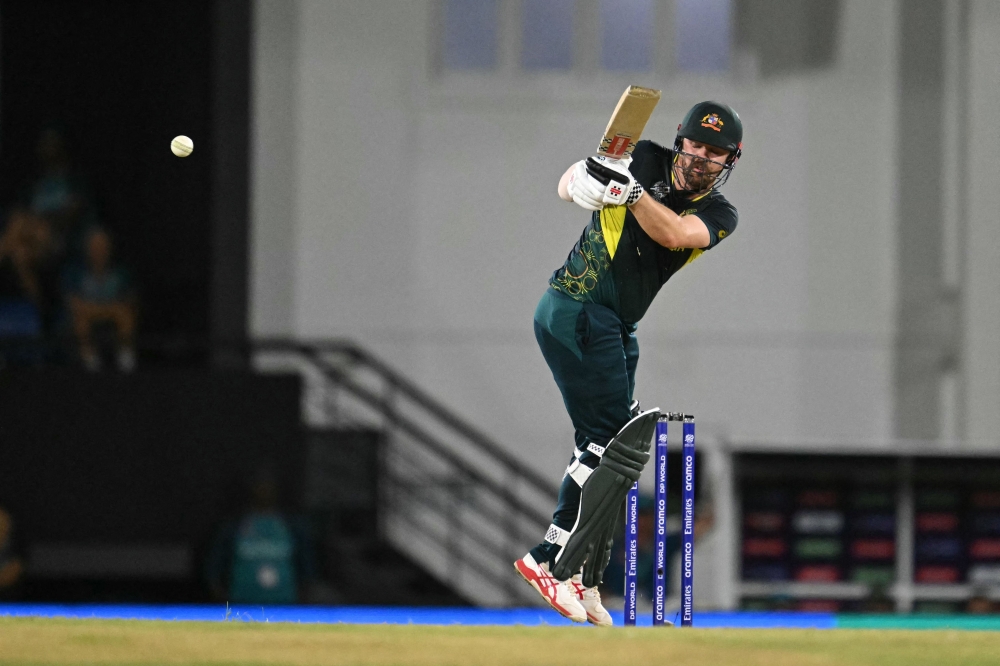 Australia's Travis Head plays a shot during the ICC men's Twenty20 World Cup 2024 group B cricket match between Australia and Scotland at Daren Sammy Cricket Ground in Gros Islet, St. Lucia, June 15, 2024. (Photo by Timothy A. Clary / AFP)