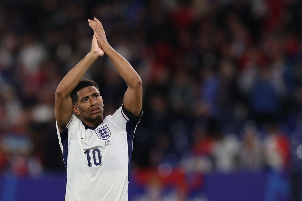 England's midfielder #10 Jude Bellingham greets the fans at the end of the UEFA Euro 2024 Group C football match between Serbia and England at the Arena AufSchalke in Gelsenkirchen on June 16, 2024. (Photo by Adrian DENNIS / AFP)
