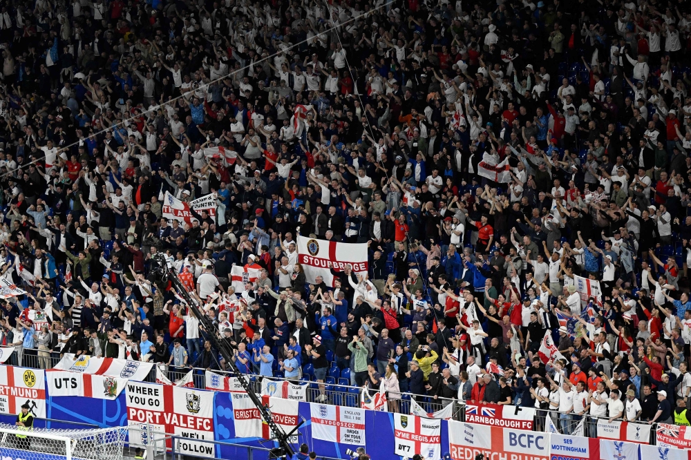 England fans celebrate at the end of the UEFA Euro 2024 Group C football match between Serbia and England at the Arena AufSchalke in Gelsenkirchen on June 16, 2024. (Photo by Ina Fassbender / AFP)