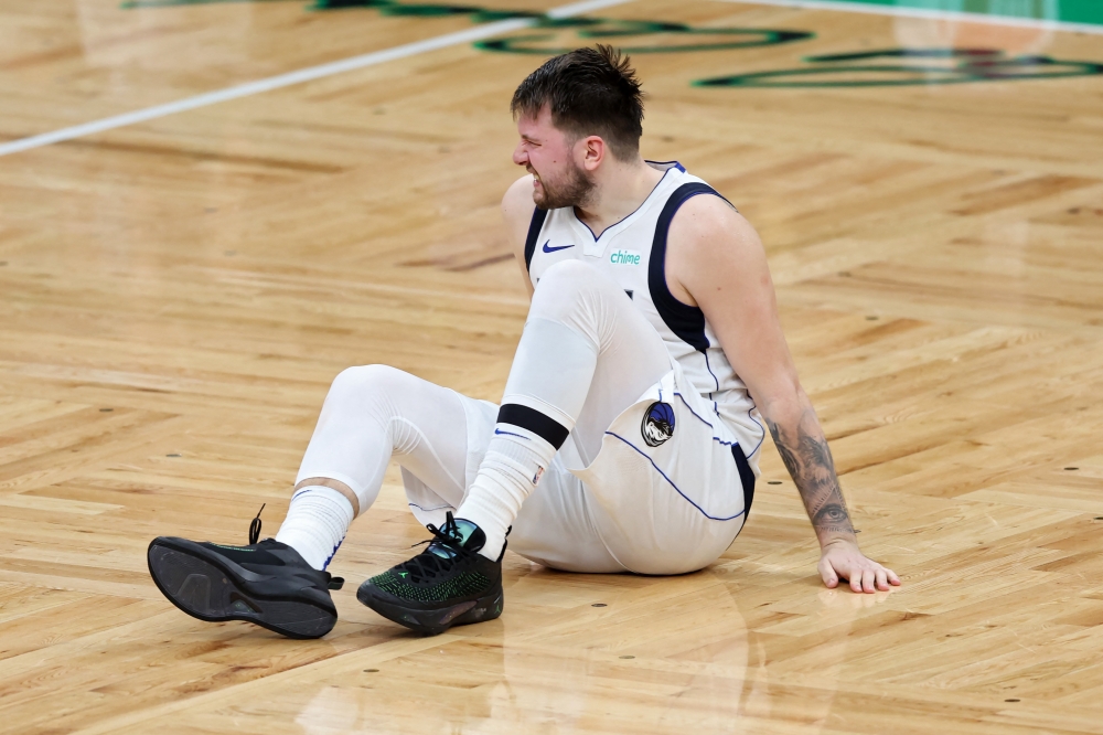 Luka Doncic #77 of the Dallas Mavericks reacts after slipping against the Boston Celtics during the fourth quarter of Game Five of the 2024 NBA Finals at TD Garden on June 17, 2024 in Boston, Massachusetts. (Photo by Adam Glanzman / GETTY IMAGES NORTH AMERICA / Getty Images via AFP)
