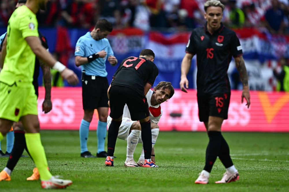 Croatia's midfielder #10 Luka Modric (C) reacts at the end of the UEFA Euro 2024 Group B football match between Croatia and Albania at the Volksparkstadion in Hamburg on June 19, 2024. (Photo by GABRIEL BOUYS / AFP)
