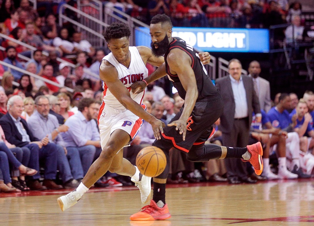 Detroit Pistons forward Stanley Johnson (7) and Houston Rockets guard James Harden (13) reach for a loose ball in the second half at Toyota Center. Detroit Pistons won 114-109 .Credit: Thomas B. Shea

