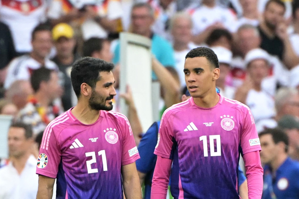 Germany's midfielder #21 Ilkay Gundogan (L) and Germany's midfielder #10 Jamal Musiala celebrate after winning the UEFA Euro 2024 Group A football match between Germany and Hungary at the Stuttgart Arena in Stuttgart on June 19, 2024. (Photo by DAMIEN MEYER / AFP)
