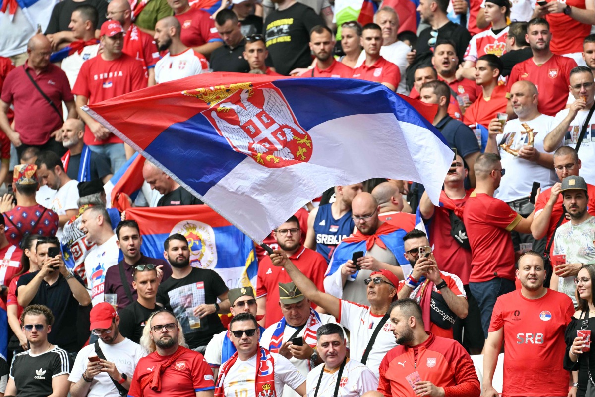 A Serbia supporter waves the national flag prior to the UEFA Euro 2024 Group C football match between Slovenia and Serbia at the Munich Football Arena in Munich on June 20, 2024. (Photo by MIGUEL MEDINA / AFP)