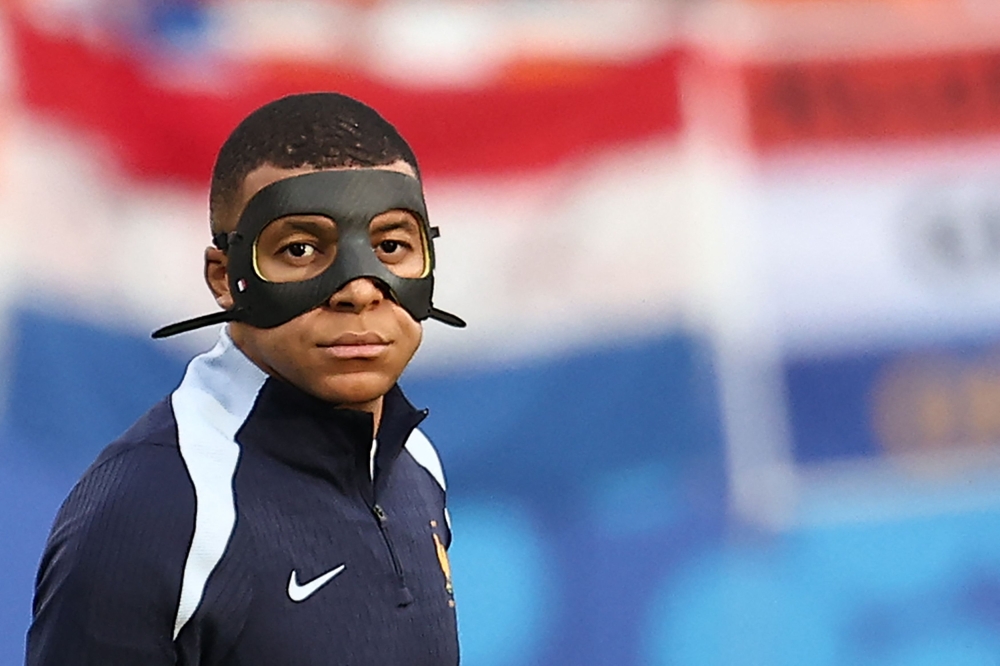 France's forward #10 Kylian Mbappe walks on the pitch during warm up prior to the UEFA Euro 2024 Group D football match between the Netherlands and France at the Leipzig Stadium in Leipzig on June 21, 2024. (Photo by Franck Fife / AFP)
