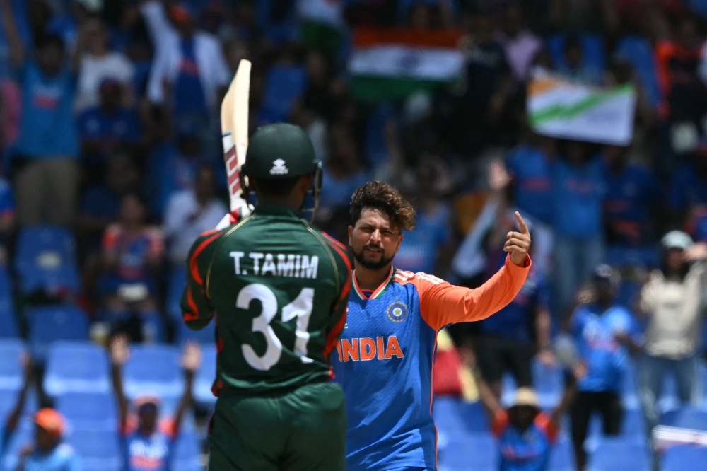 India's Kuldeep Yadav celebrates an lbw out of Bangladesh's Tanzid Hasan Tamim during the ICC men's Twenty20 World Cup 2024 Super Eight cricket match between India and Bangladesh at Sir Vivian Richards Stadium in North Sound, Antigua and Barbuda, on June 22, 2024. (Photo by ANDREW CABALLERO-REYNOLDS / AFP)
