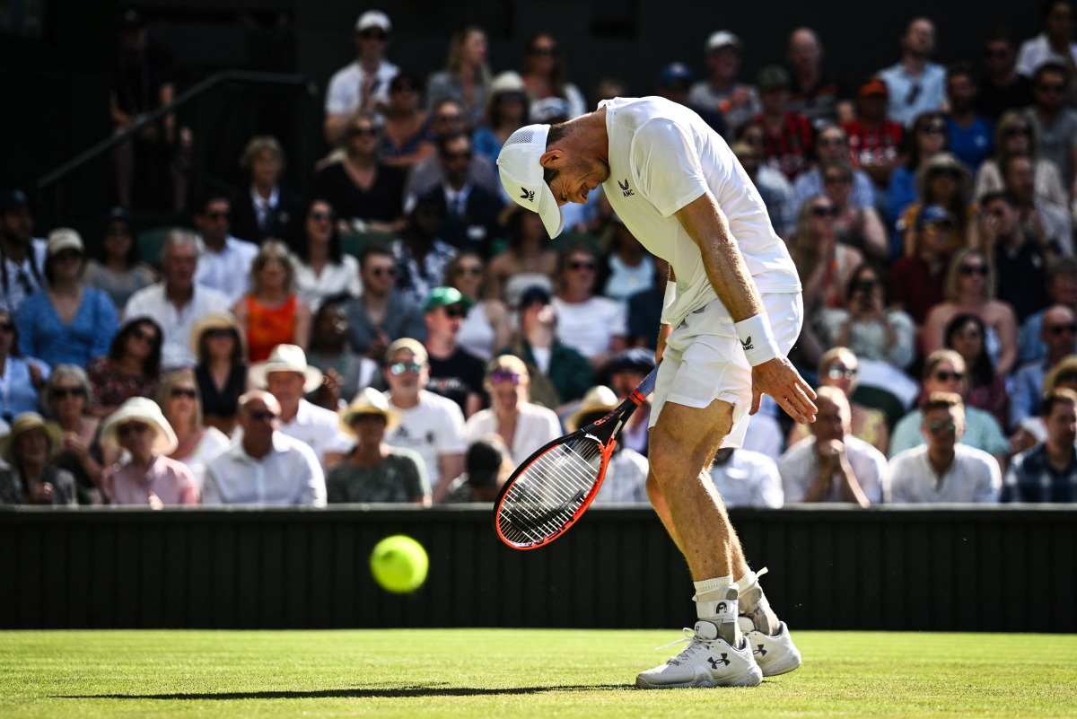 FILES: Britain's Andy Murray reacts as he plays against Greece's Stefanos Tsitsipas during their men's singles tennis match on the fifth day of the 2023 Wimbledon Championships at The All England Tennis Club in Wimbledon, southwest London, on July 7, 2023. (Photo by SEBASTIEN BOZON / AFP)