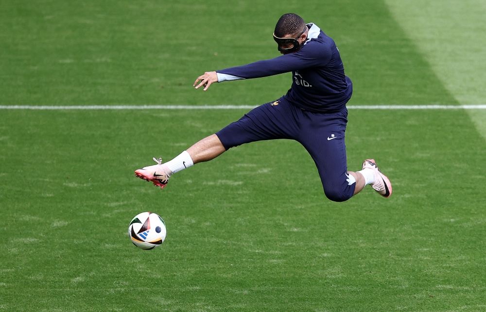 France's forward #10 Kylian Mbappe kicks the ball during a training session at the Home Deluxe Arena Stadium in Paderborn, western Germany, on June 23, 2024, during of the UEFA Euro 2024 football championship. (Photo by Franck Fife / AFP)