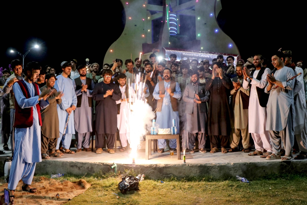 Afghan fans burst firecrackers in Khost on June 23, 2024 to celebrate Afghanistan's win against Australia at their ICC men's Twenty20 World Cup 2024 Super Eight cricket match. (Photo by AFP)