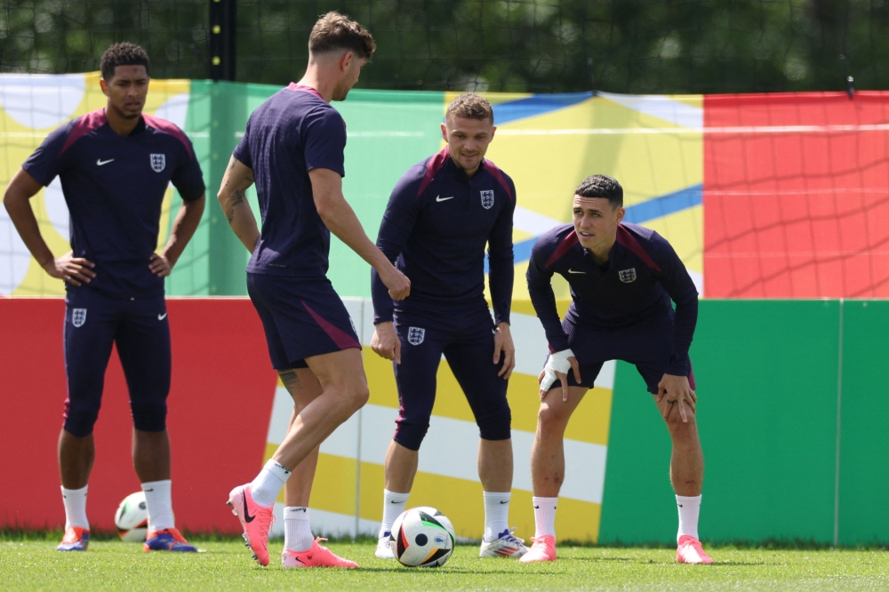 (From L) England's midfielder #10 Jude Bellingham, England's defender #05 John Stones, England's defender #12 Kieran Trippier and England's midfielder #11 Phil Foden attend a MD-1 training session during the UEFA Euro 2024 European Football Championship, at the team's base camp in Blankenhain, Thuringia, on June 24, 2024, on the eve of their UEFA Euro 2024 Group C football match against Slovenia. (Photo by Adrian DENNIS / AFP)
