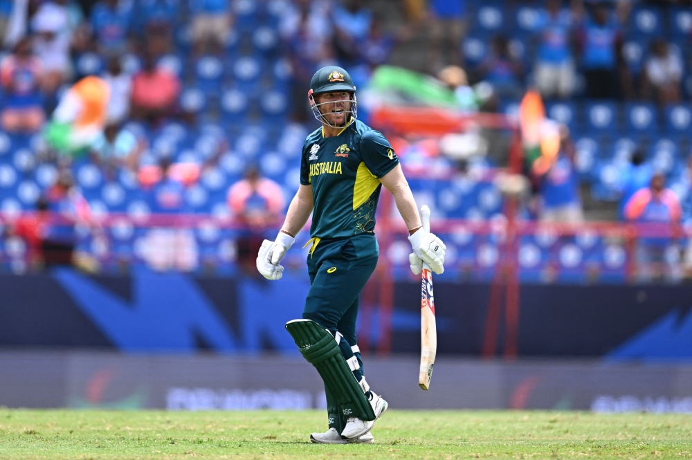 Australia's David Warner reacts after getting dismissed during the ICC men's Twenty20 World Cup 2024 Super Eight cricket match between Australia and India on June 24, 2024. (Photo by Chandan Khanna / AFP)