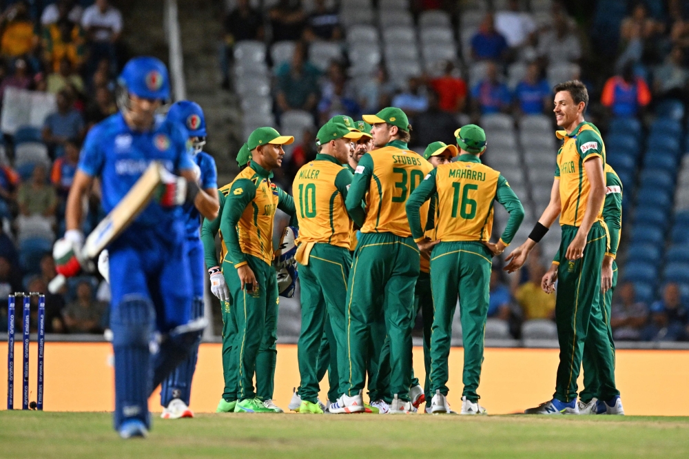 South Africa's players celebrate after Afghanistan's Rahmanullah Gurbaz (L) is run out during the ICC men's Twenty20 World Cup 2024 semi-final cricket match between South Africa and Afghanistan at Brian Lara Cricket Academy in Tarouba, Trinidad and Tobago, on June 26, 2024. (Photo by Chandan Khanna / AFP)