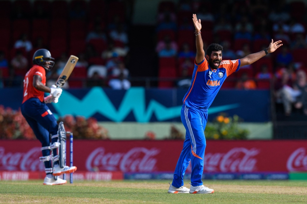 India's Jasprit Bumrah celebrates the dismissal of England's Jofra Archer (left) during the ICC men's Twenty20 World Cup 2024 semi-final cricket match between India and England at Providence Stadium in Georgetown, Guyana, on June 27, 2024. (Photo by Randy Brooks / AFP)