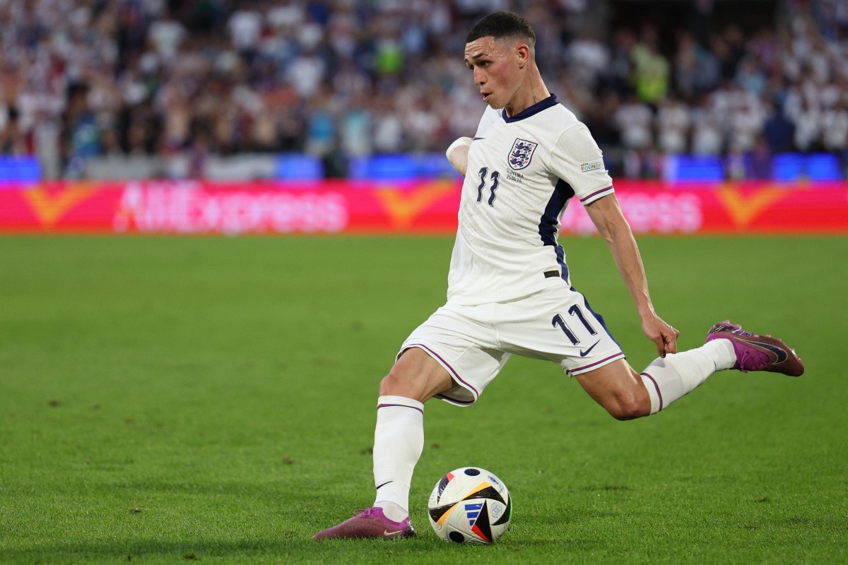 England's midfielder #11 Phil Foden crosses the ball during the UEFA Euro 2024 Group C football match between England and Slovenia at the Cologne Stadium in Cologne on June 25, 2024. (Photo by Adrian DENNIS / AFP)