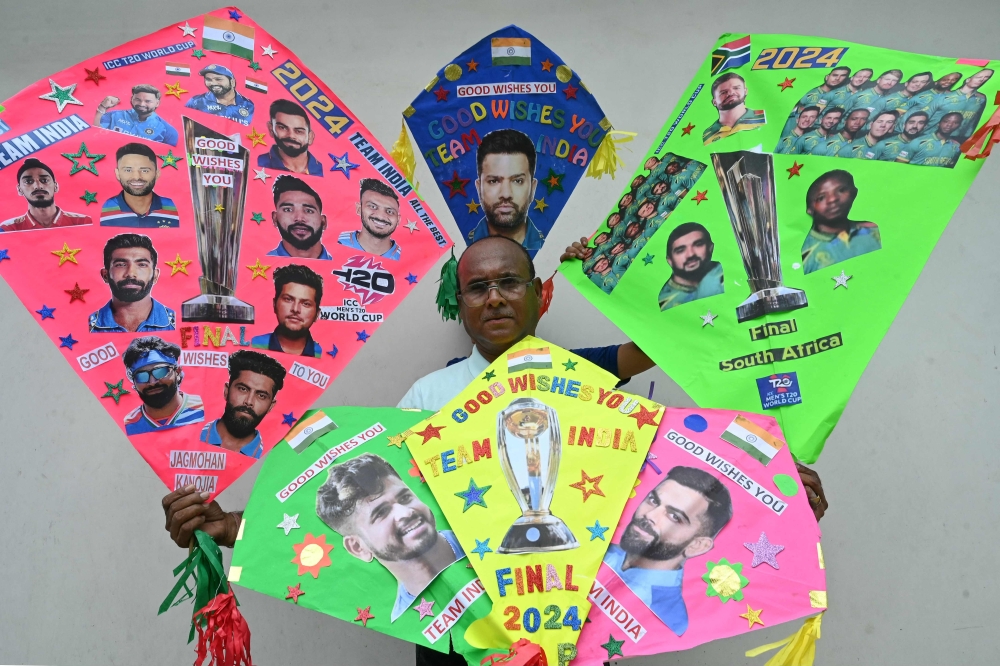 A kitemaker displays his kites decorated with pictures of Indian and South African cricket players in Amritsar on June 28, 2024, on the eve of the ICC men's Twenty20 World Cup 2024 final cricket match between India and South Africa. (Photo by Narinder NANU / AFP)
