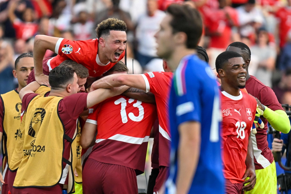 Switzerland's midfielder #17 Ruben Vargas (Top L), Switzerland's forward #18 Kwadwo Duah (R) celebrate at the end of the UEFA Euro 2024 round of 16 football match between Switzerland and Italy at the Olympiastadion Berlin in Berlin on June 29, 2024. (Photo by Fabrice COFFRINI / AFP)
