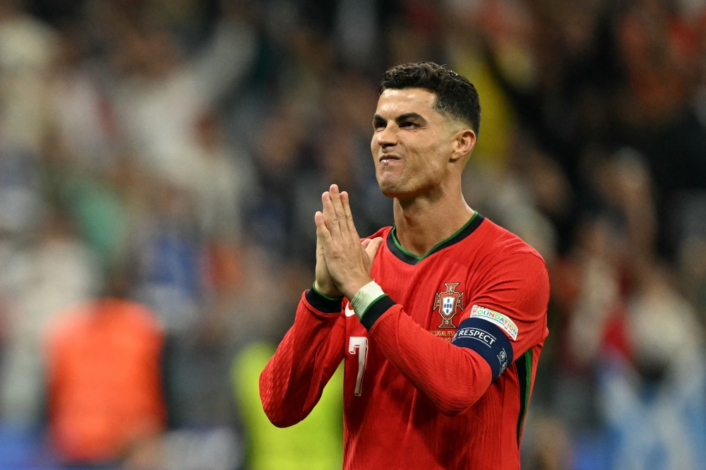 Portugal's forward Cristiano Ronaldo reacts after scoring in a penalty shoot-out in Frankfurt am Main on July 1, 2024. (Photo by Patricia De Melo Moreira / AFP)