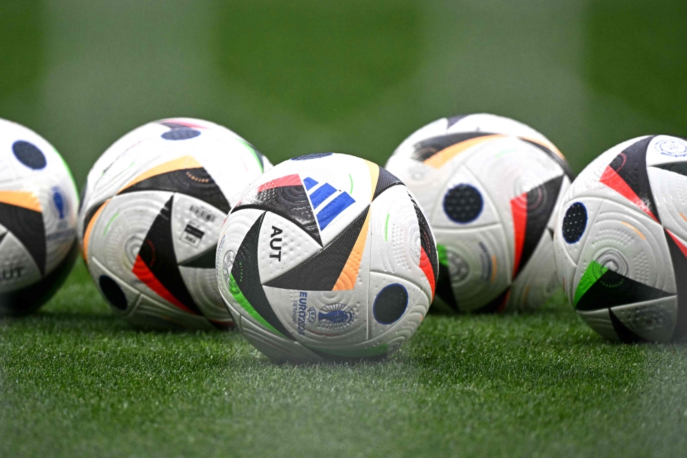 A photo shows tournament balls on the pitch prior to the UEFA Euro 2024 round of 16 football match between Austria and Turkey at the Leipzig Stadium in Leipzig on July 2, 2024. (Photo by Javier Soriano / AFP)