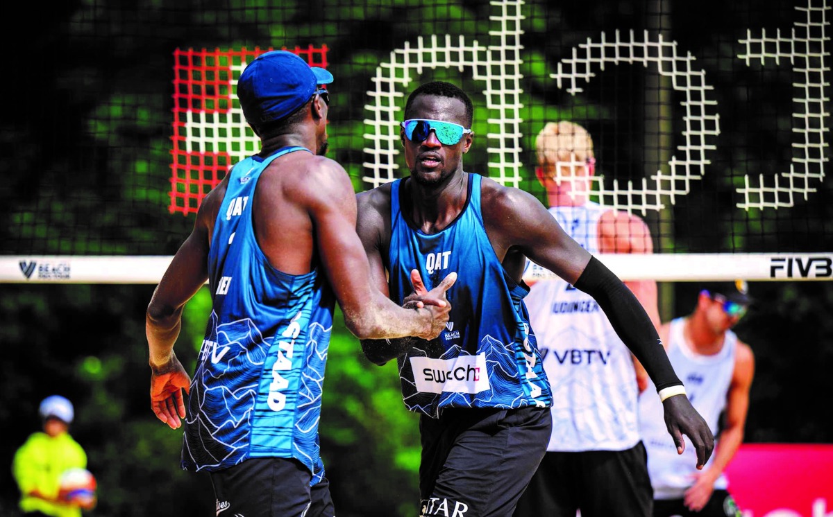 Qatar's Cherif Younousse and Ahmed Tijan celebrate after defeating USA's Chase Budinger and Miles Evans in their opening match of Elite16 Volleyball World Beach Pro Tour encounter in Gstaad, Switzerland, yesterday.