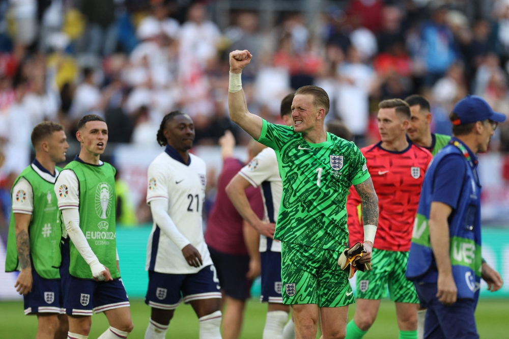 England's goalkeeper #01 Jordan Pickford celebrates after winning the UEFA Euro 2024 quarter-final football match between England and Switzerland at the Duesseldorf Arena in Duesseldorf on July 6, 2024. (Photo by Adrian DENNIS / AFP)
