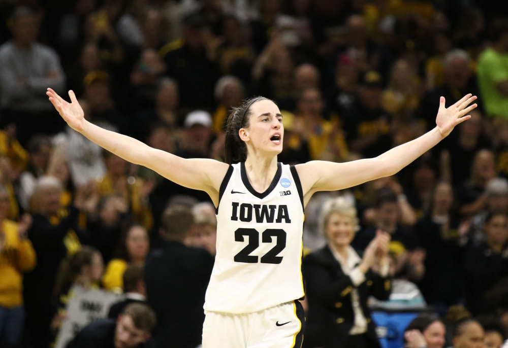 Guard Caitlin Clark #22 of the Iowa Hawkeyes celebrates after drawing a foul late in the second half against the West Virginia Mountaineers during their second round match-up in the 2024 NCAA Division 1 Women's Basketball Championship at Carver-Hawkeye Arena on March 25, 2024 in Iowa City, Iowa. (Photo by Matthew Holst / GETTY IMAGES NORTH AMERICA / Getty Images via AFP)

