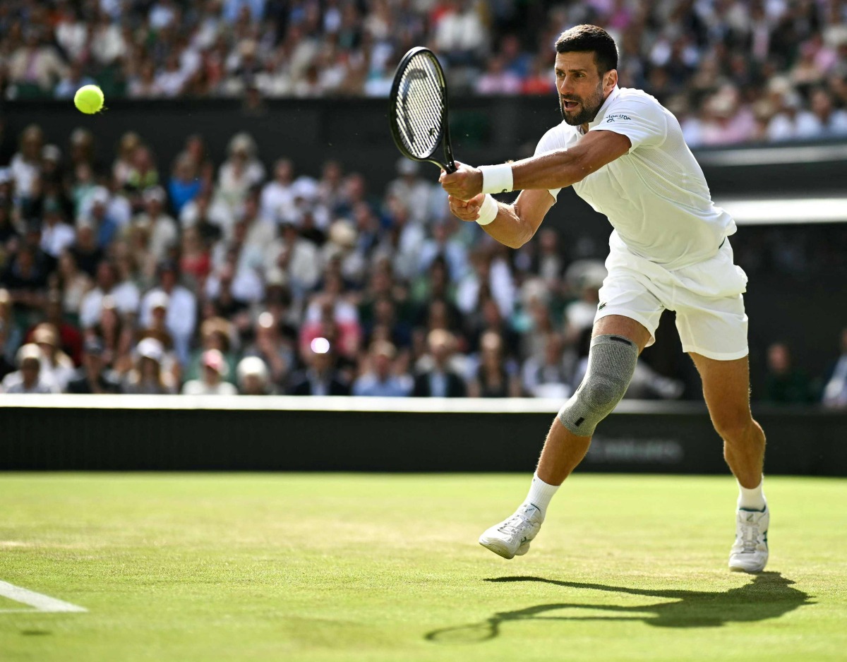 Serbia's Novak Djokovic returning the ball on the fourth day of the 2024 Wimbledon Championships on July 4, 2024. (Photo by Ben Stansall / AFP) 