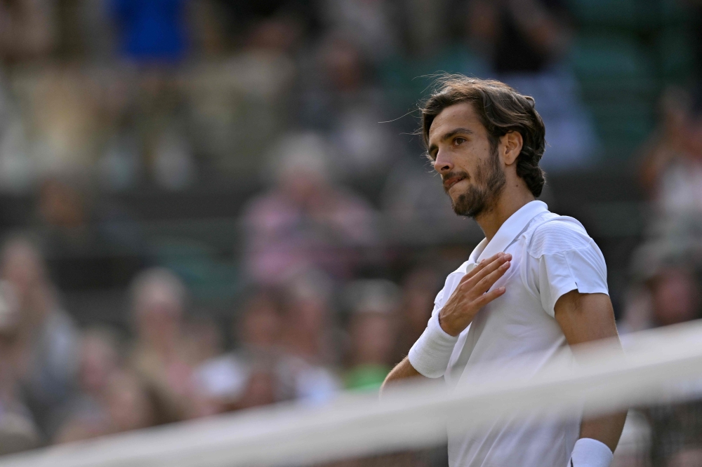 Italy's Lorenzo Musetti celebrates winning against US player Taylor Fritz during their men's singles quarter-finals tennis match on the tenth day of the 2024 Wimbledon Championships at The All England Lawn Tennis and Croquet Club in Wimbledon, southwest London, on July 10, 2024. (Photo by Andrej Isakovic / AFP) 