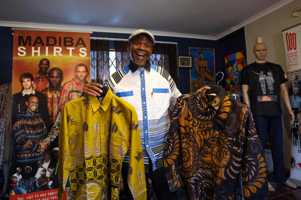 Sonwabile Ndamase, who used to design and style for the late former President of South Africa Nelson Mandela and the designer of the original Madiba shirt, shows some of his latest designs on July 4, 2024. (Photo by Phill Magakoe / AFP)