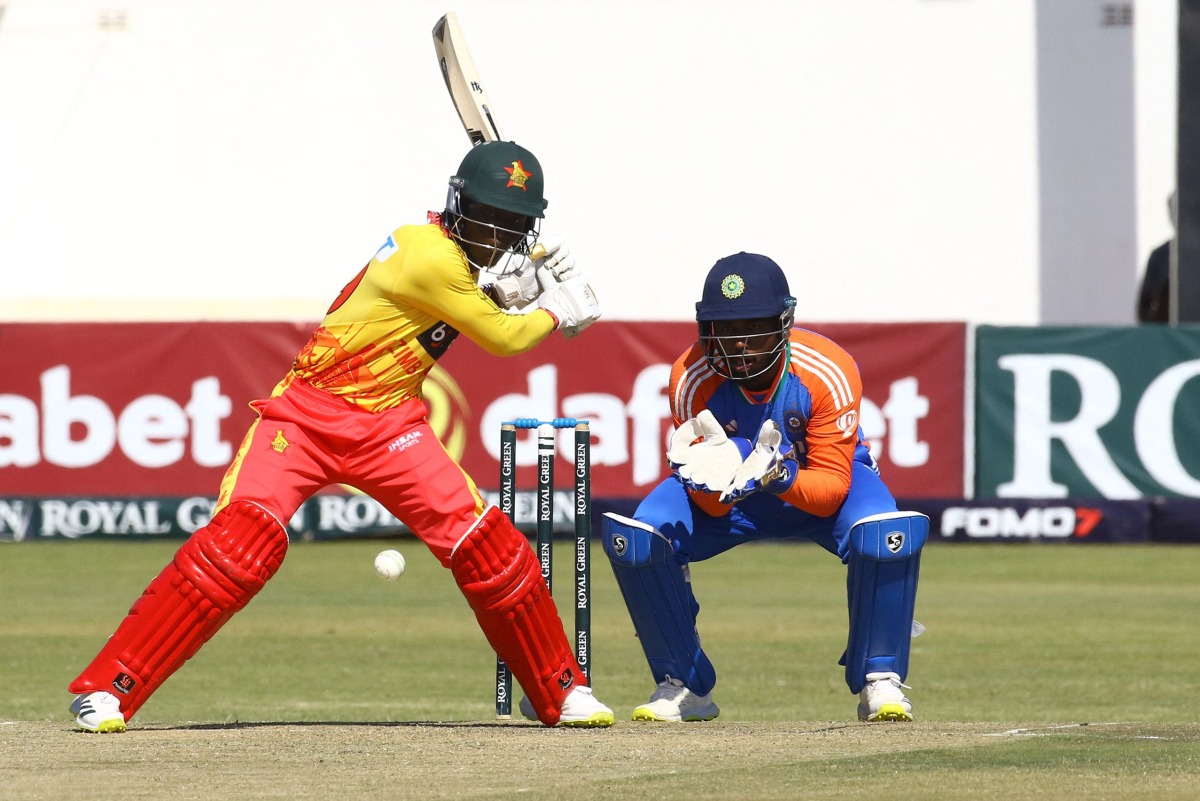 Zimbabwe's Tadiwanashe Marumani (L) plays a shot as India's Sanju Samson (R) looks on during the fourth T20 International cricket match between Zimbabwe and India at Harare Sports Club in Harare on July 13, 2024. (Photo by Jekesai NJIKIZANA / AFP)
