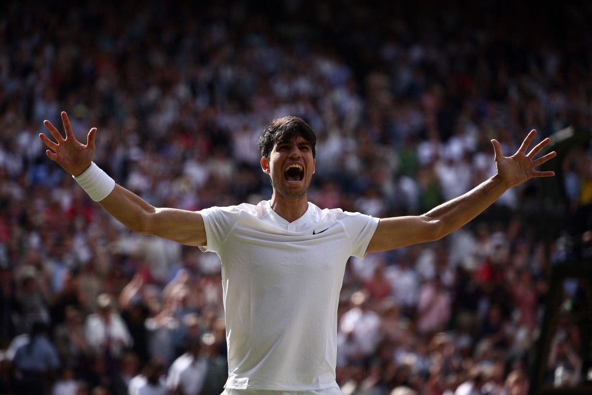 Spain's Carlos Alcaraz celebrates beating Serbia's Novak Djokovic during their men's singles final tennis match on the fourteenth day of the 2024 Wimbledon Championships at The All England Lawn Tennis and Croquet Club in Wimbledon, southwest London, on July 14, 2024.(Photo by HENRY NICHOLLS / AFP) 