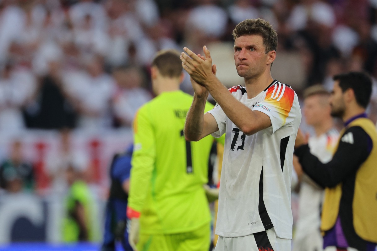 (Files) Germany's forward #13 Thomas Mueller greets the fans after the UEFA Euro 2024 quarter-final football match between Spain and Germany on July 5, 2024. (Photo by Lluis Gene / AFP)