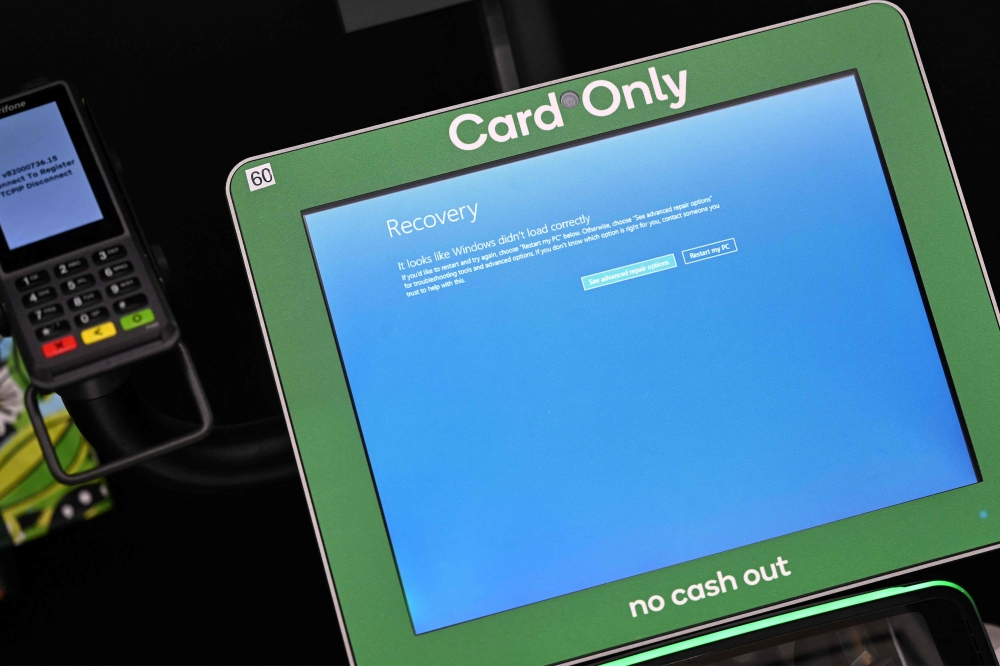 A blue screen is seen at self-checkout terminals of a supermarket in Sydney on July 19, 2024. Photo by Saeed KHAN / AFP