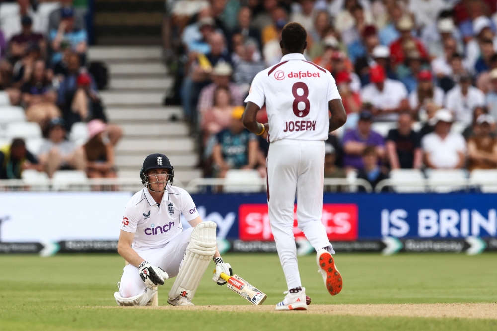 England's Harry Brook reacts after being struck by a ball from West Indies Alzarri Joseph on the third day of the second Test cricket match between England and West Indies at Trent Bridge in Nottingham on July 20, 2024. (Photo by Darren Staples / AFP)