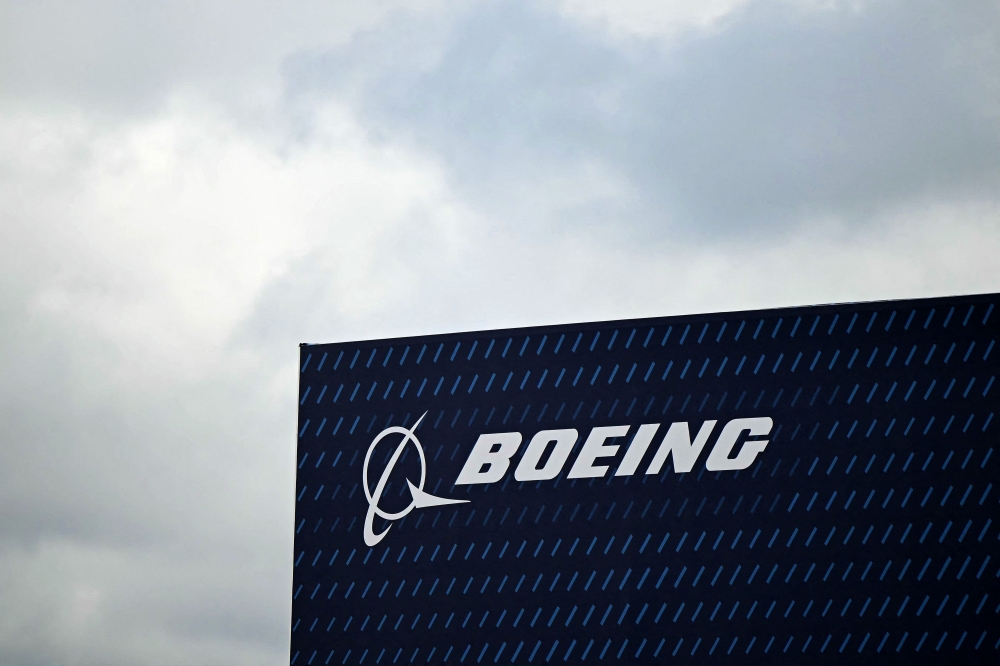 A logo is seen on the Boeing stand on the opening day of the Farnborough International Airshow 2024, south west of London, on July 22, 2024. (Photo by JUSTIN TALLIS / AFP)